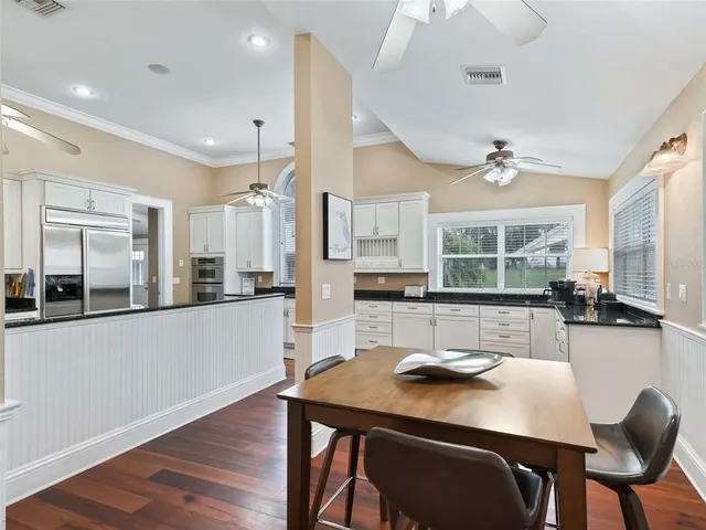 a living room with lots of furniture and kitchen view