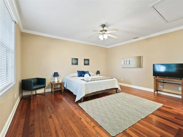 a view of a street with a big yard and palm trees