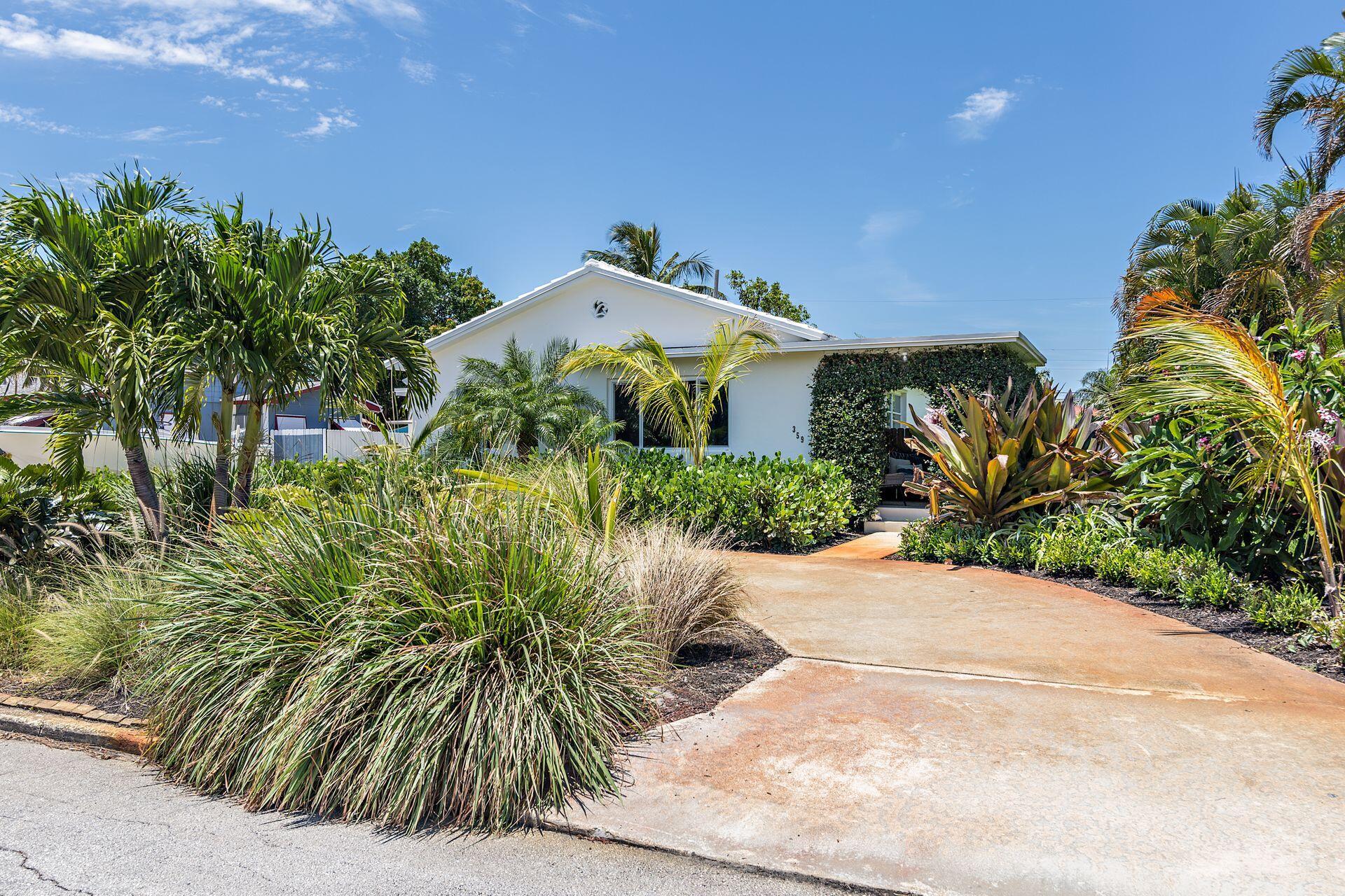 359 Ellamar Road West Palm Beach, FL 33405 - Photo 21 of 28 a view of a palm plant in front of a house
