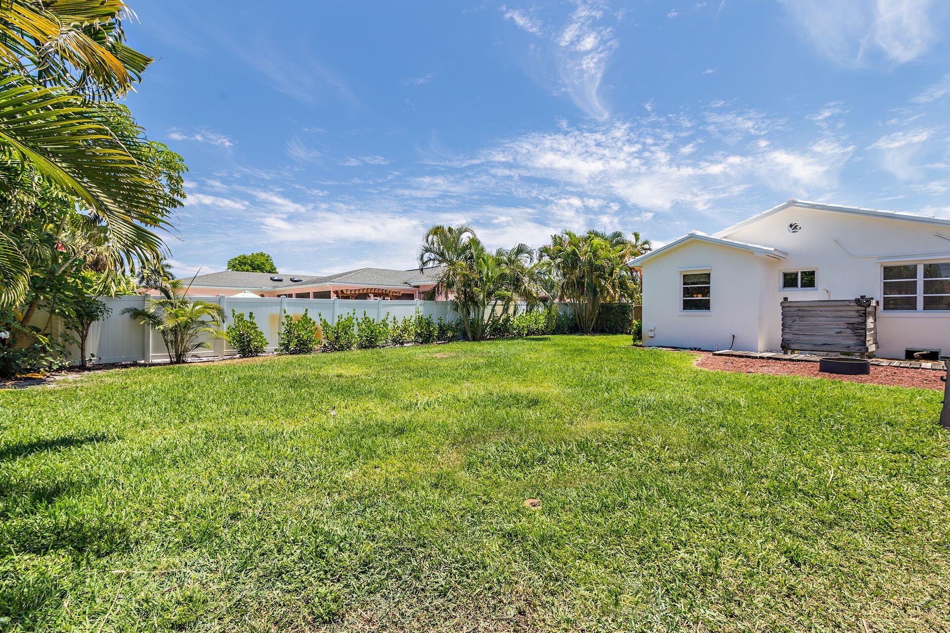359 Ellamar Road West Palm Beach, FL 33405 - Photo 24 of 28 a front view of house with yard and green space