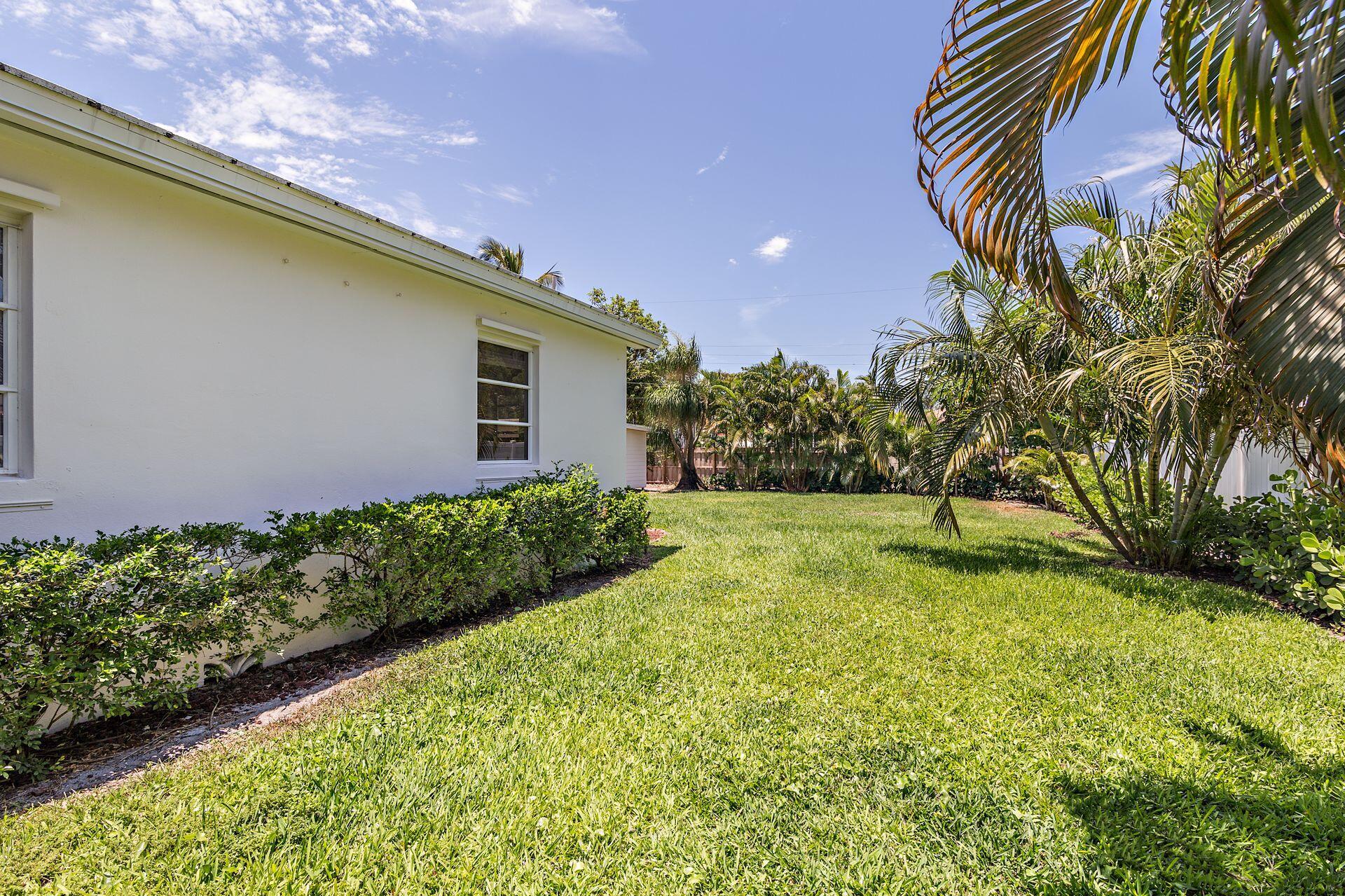 359 Ellamar Road West Palm Beach, FL 33405 - Photo 25 of 28 a view of a backyard with plants and large trees