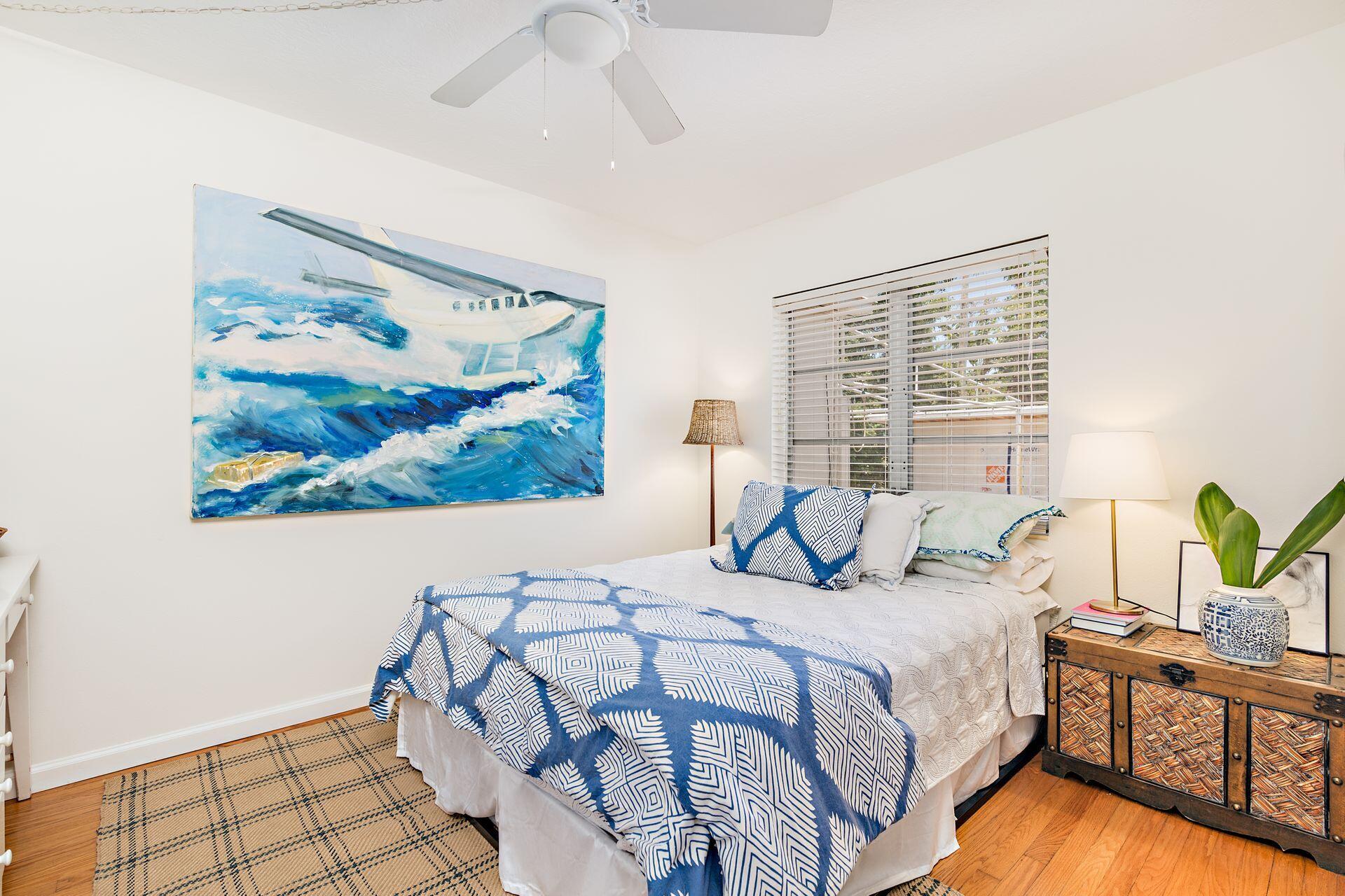 359 Ellamar Road West Palm Beach, FL 33405 - Photo 8 of 28 a bedroom with a bed and a painting on the wall