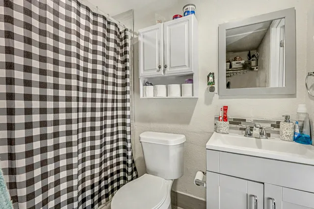a bathroom with a sink toilet and shower