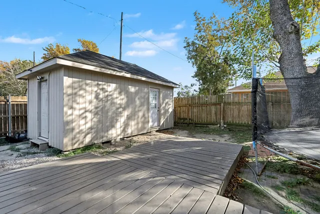 a view of a house with a wooden fence
