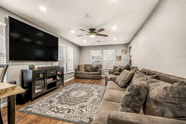 a living room with furniture and a flat screen tv