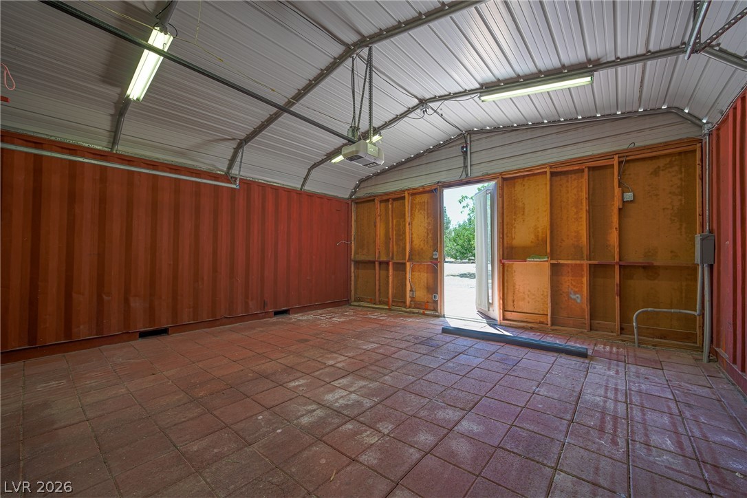 1831 West Horn Road Pahrump, NV 89048 - Photo 43 of 59 Secure storage solution, featuring durable corrugated metal construction and an overhead door.
