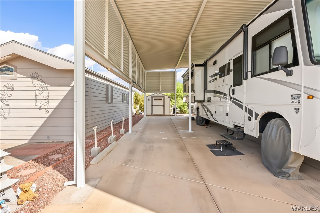 2000 Ramar Road, Unit 227 Bullhead City, AZ 86442 - Photo 11 of 40 Under the awning? a long, clean drive with added privacy panels and plenty of room to move around.