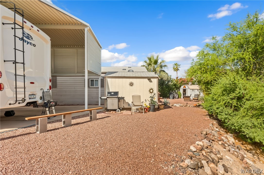 2000 Ramar Road, Unit 227 Bullhead City, AZ 86442 - Photo 13 of 40 Spacious backyard setup with RV parking, shade from the extended awning, and room to relax or entertain.