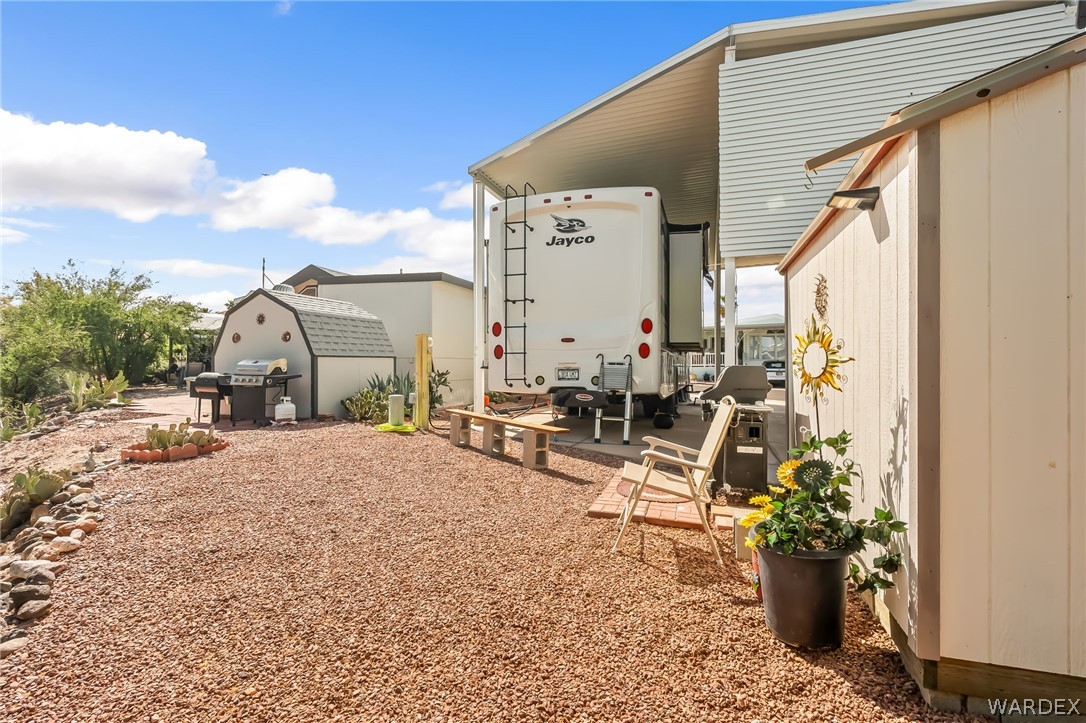 2000 Ramar Road, Unit 227 Bullhead City, AZ 86442 - Photo 15 of 40 Wide open yard with RV access, seating area, and additional storage?designed for comfort and functionality.