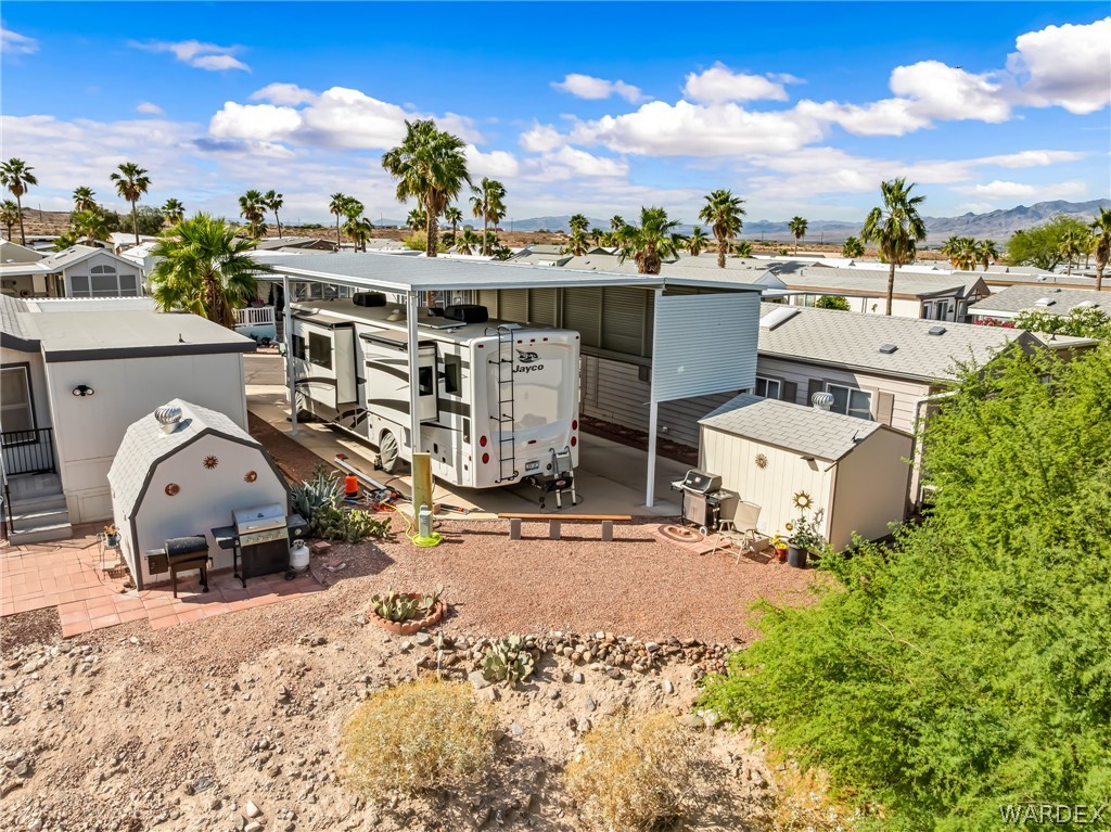 2000 Ramar Road, Unit 227 Bullhead City, AZ 86442 - Photo 19 of 40 Full backyard view with RV setup, entertaining space, and extended awning for all-day shade.