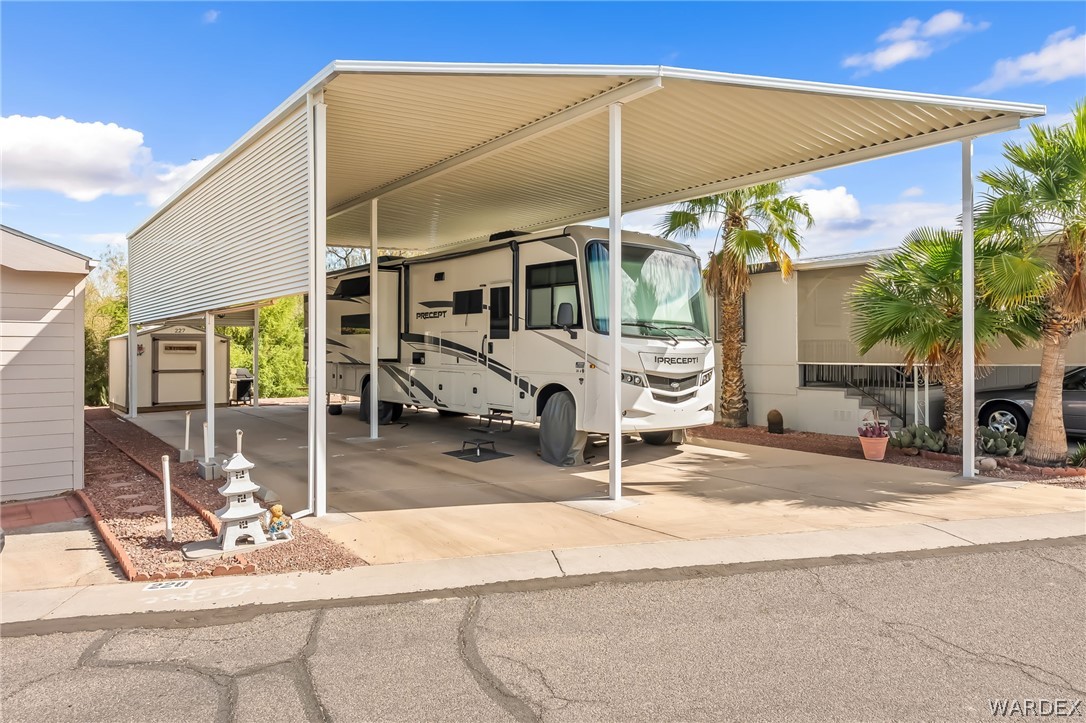 2000 Ramar Road, Unit 227 Bullhead City, AZ 86442 - Photo 6 of 40 Bright and open RV port with ample clearance and side access, complemented by low-maintenance landscaping and a functional layout for everyday ease.