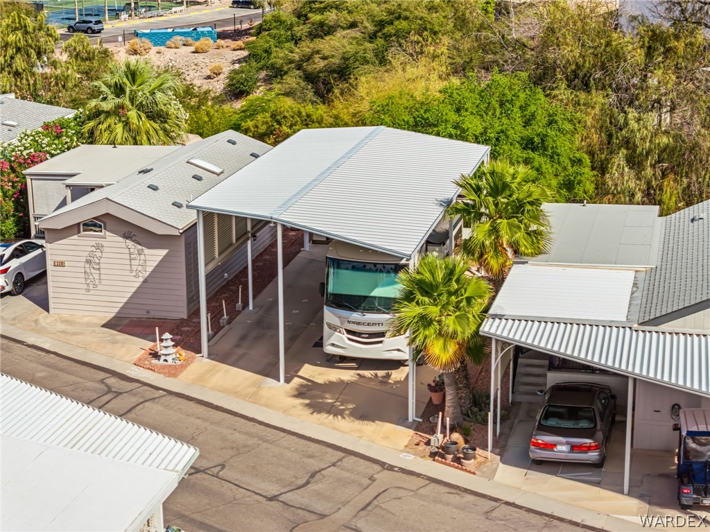 2000 Ramar Road, Unit 227 Bullhead City, AZ 86442 - Photo 7 of 40 Elevated view showcasing a spacious, fully covered RV port with clean lines, mature landscaping, and easy access?perfectly positioned for both convenience and curb appeal.