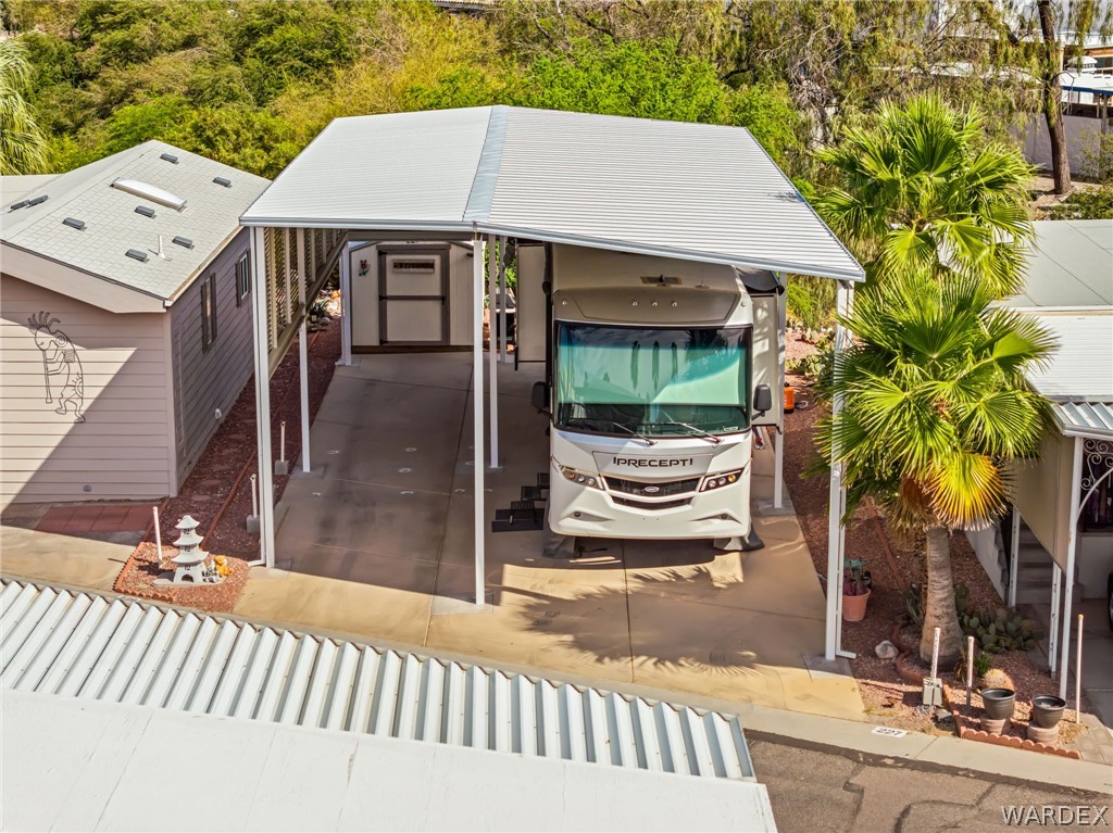 2000 Ramar Road, Unit 227 Bullhead City, AZ 86442 - Photo 9 of 40 Aerial perspective showing the full setup?spacious RV port with upgraded awning and surrounding greenery.