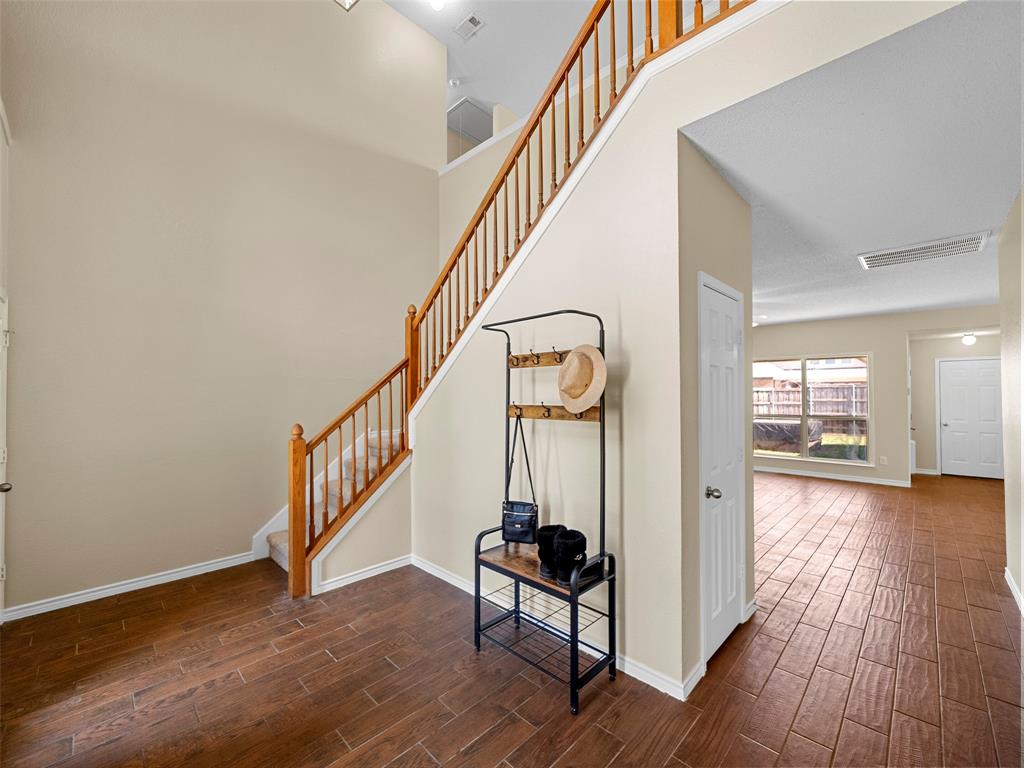 741 Aspen Court Allen, TX 75002 - Photo 10 of 40 Staircase with wood tile floors and a high ceiling