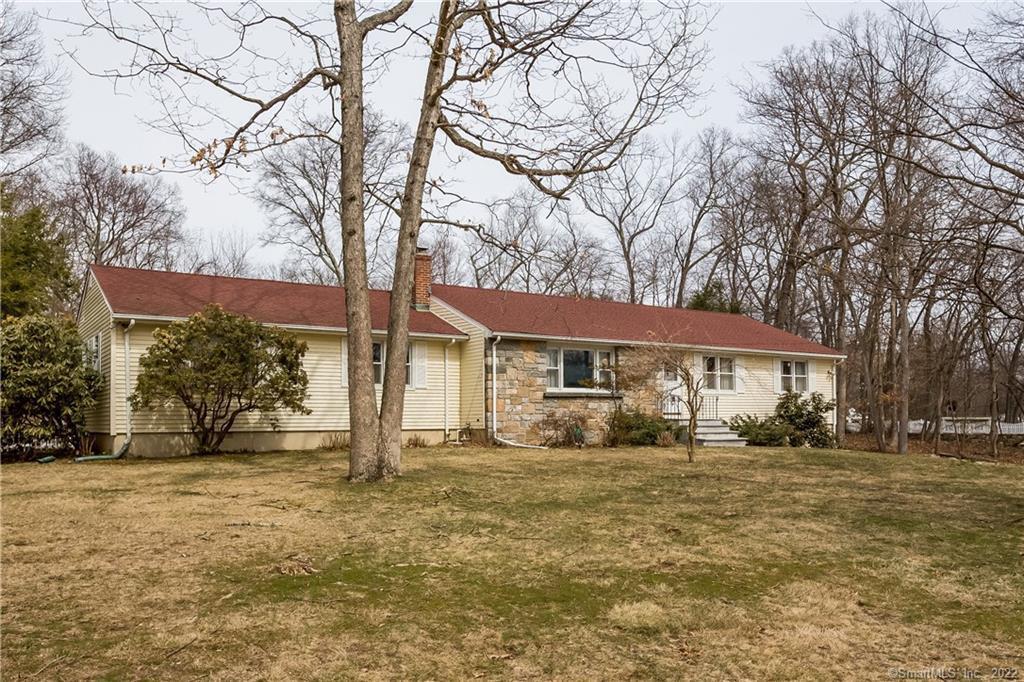 a view of a house with a yard covered in snow