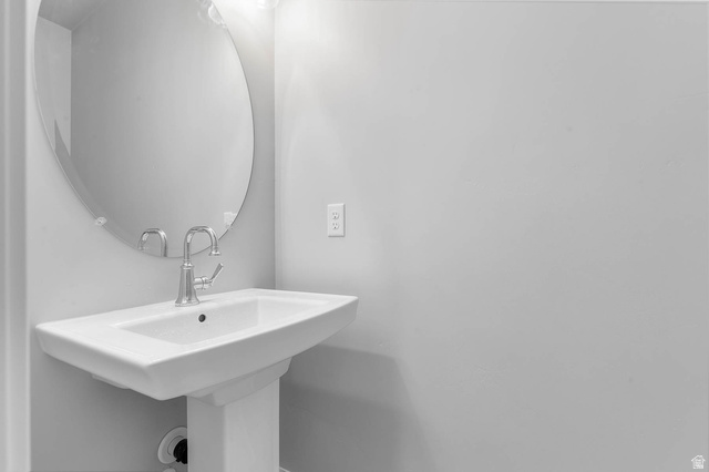 11673 South Halls Crk Road Draper, UT 84020 - Photo 17 of 22 Pedestal sink with a polished chrome faucet and an oval wall mirror