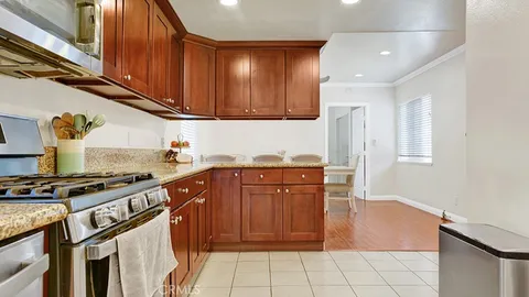 a kitchen with stainless steel appliances granite countertop a stove a sink and a refrigerator