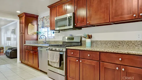 a kitchen with stainless steel appliances granite countertop a sink stove and microwave