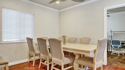 a view of a dining room with furniture and a window