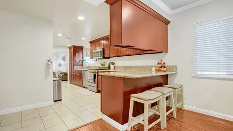 a kitchen with cabinets and chairs