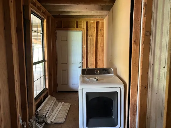 a view of a hallway with washer and dryer