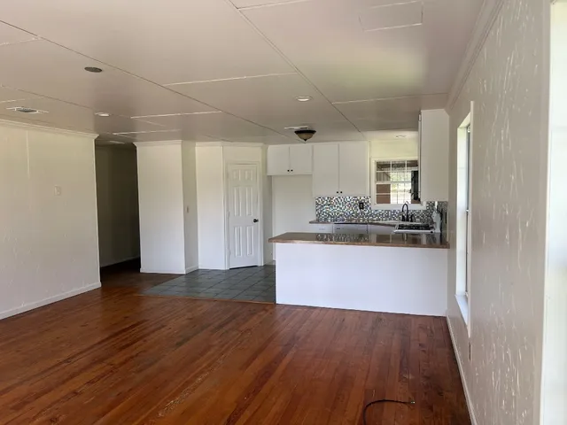 a view of kitchen cabinets and wooden floor
