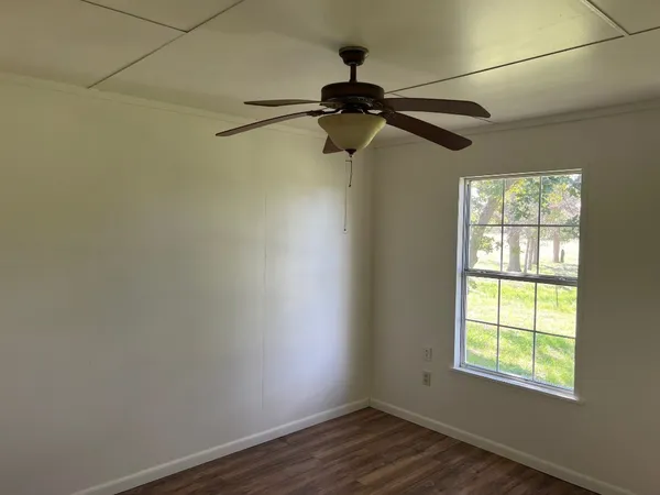 a view of a room with a window and a ceiling fan