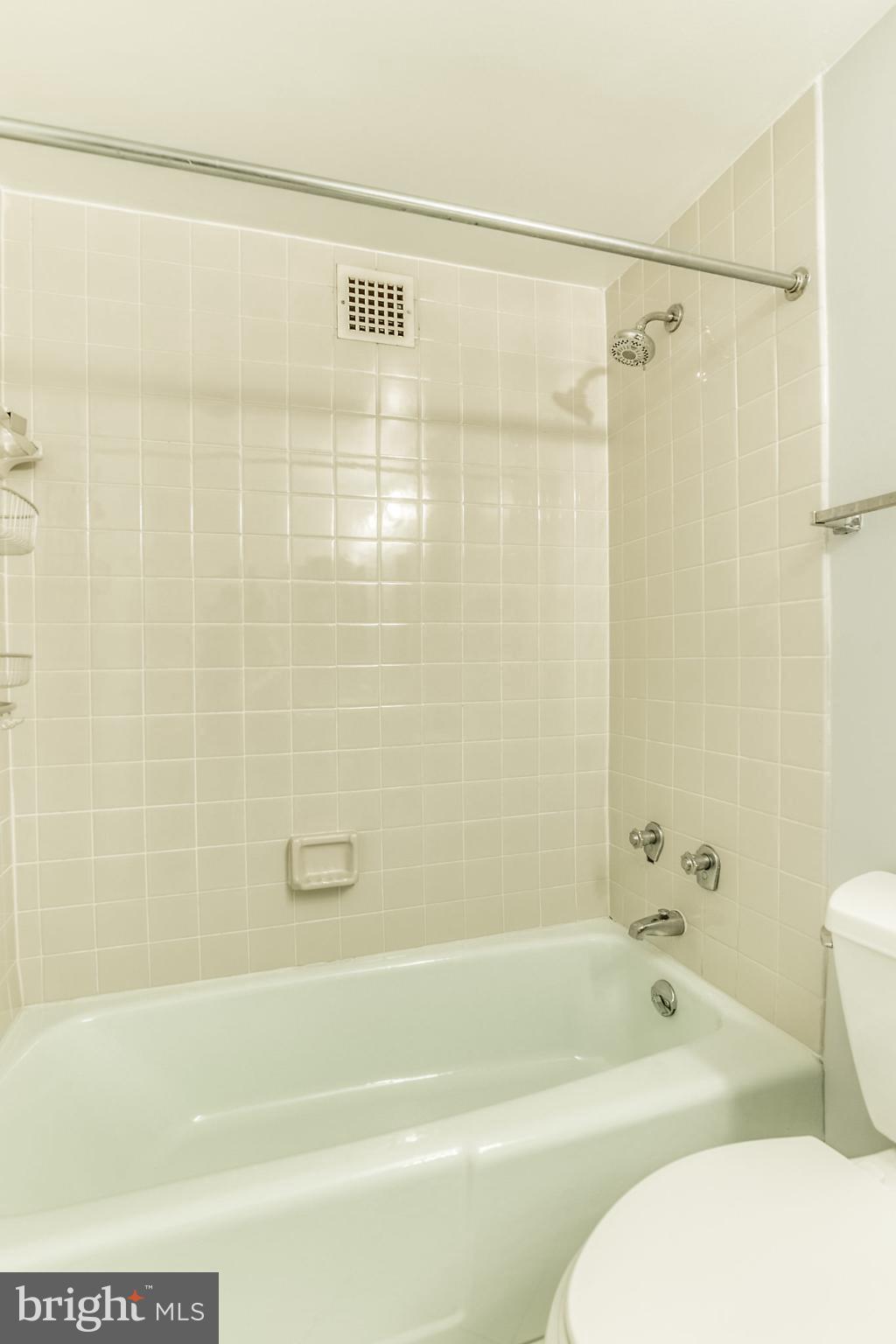 4141 North Henderson Road, Unit 1019 Arlington, VA 22203 - Photo 16 of 27 Modern bathroom with clean, tiled elegance.