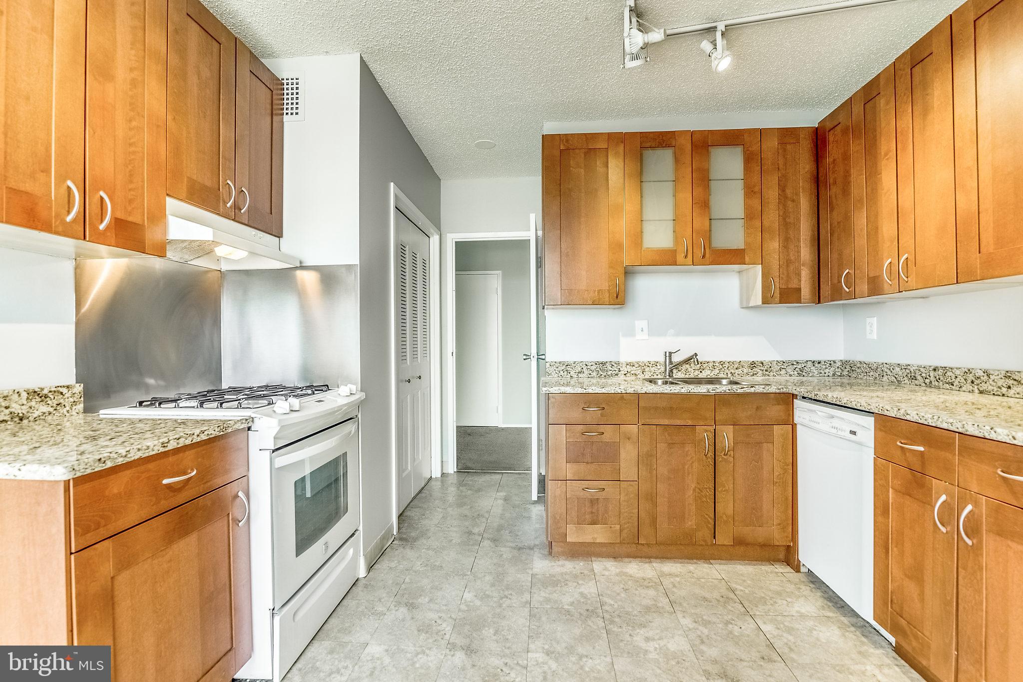 4141 North Henderson Road, Unit 1019 Arlington, VA 22203 - Photo 3 of 27 Modern kitchen with warm wood cabinetry.