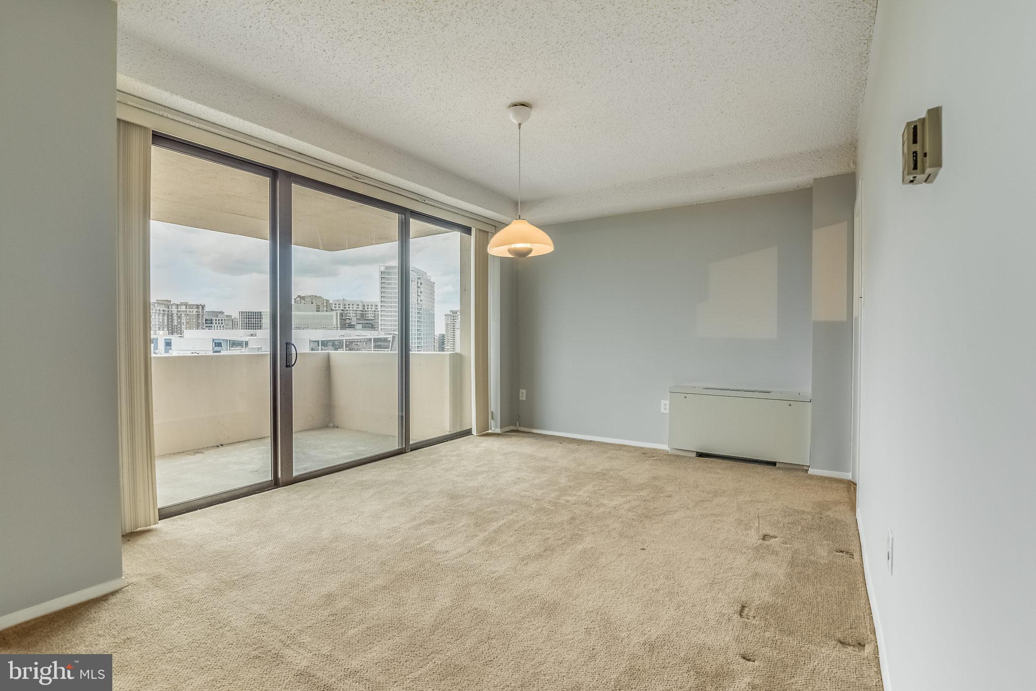 4141 North Henderson Road, Unit 1019 Arlington, VA 22203 - Photo 7 of 27 Spacious room with city skyline views.