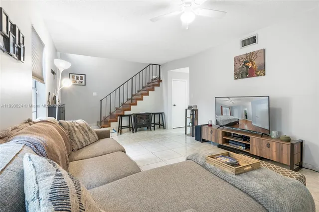 a living room with furniture and a dining table