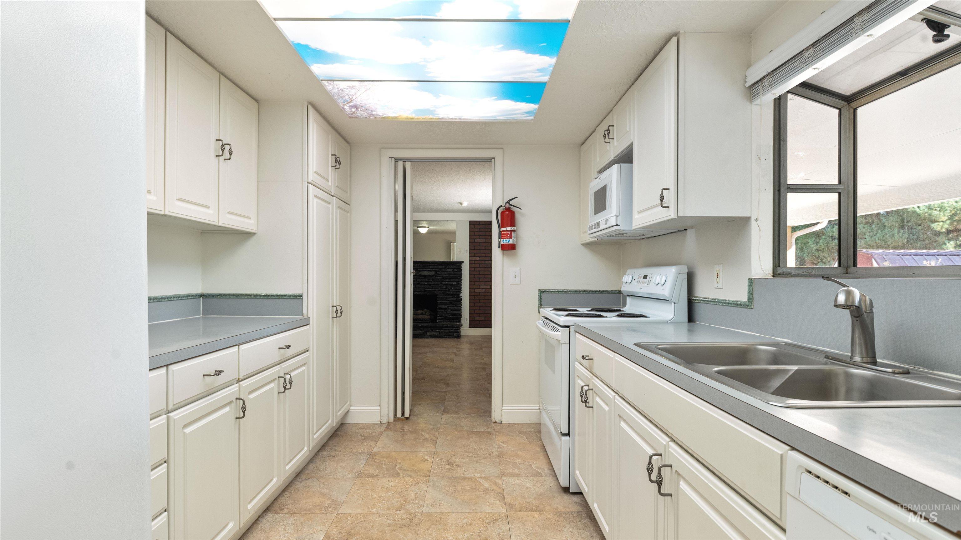 4054 North Maple Grove Road Boise, ID 83704 - Photo 15 of 34 Neutral-toned floor tiles, white walls, and a semi-flush mount ceiling light fixture