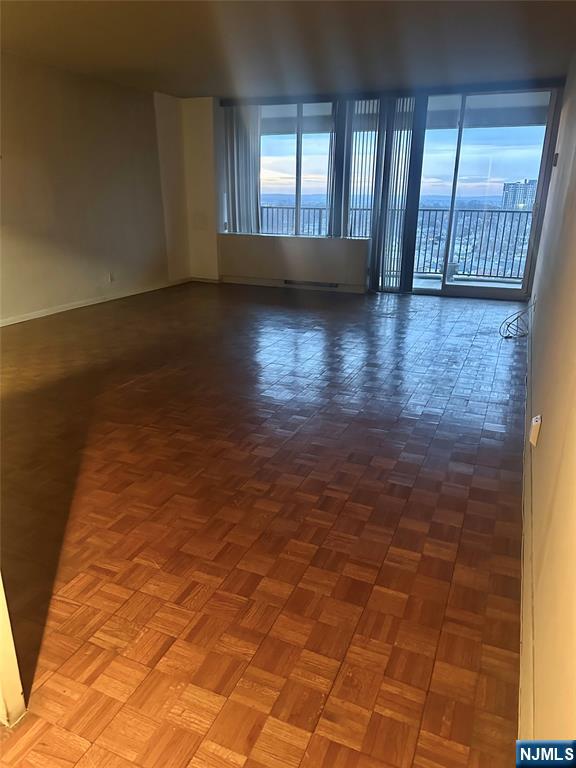 6 Horizon Road, Unit 1204 Fort Lee, NJ 07024 - Photo 9 of 19 an empty room with wooden floor and windows