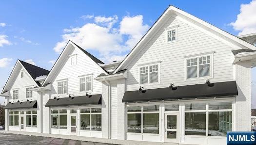 a front view of a house with a glass door and balcony