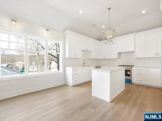 445 Ramapo Valley Road, Unit 3 Oakland, NJ 07436 - Photo 4 of 9 a large kitchen with kitchen island a large counter space a sink stainless steel appliances and cabinets