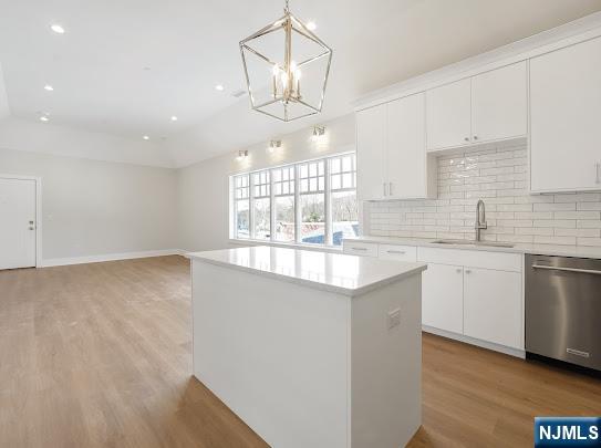 445 Ramapo Valley Road, Unit 3 Oakland, NJ 07436 - Photo 5 of 9 a kitchen that has a lot of white cabinets and wooden floor