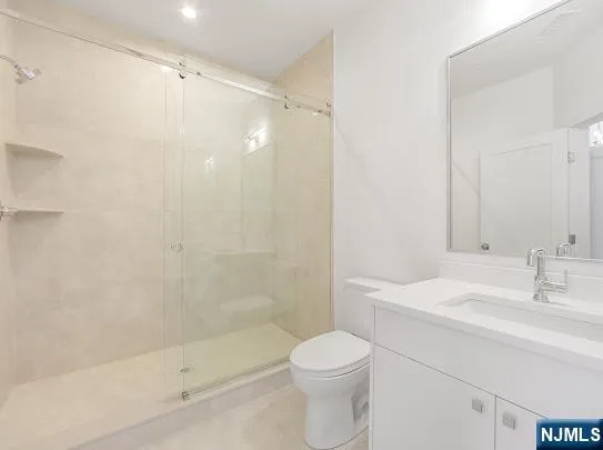 a bathroom with a bathtub shower sink vanity and toilet