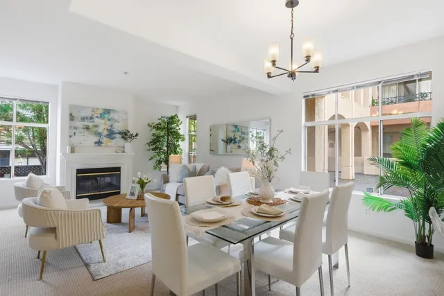 a view of a livingroom and dining room with furniture window and wooden floor