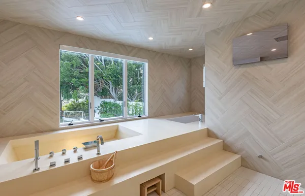 a bathroom with a tub and shower