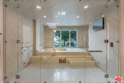 a kitchen with stainless steel appliances kitchen island granite countertop a stove and a refrigerator