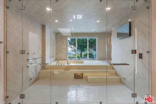 a kitchen with stainless steel appliances kitchen island granite countertop a stove and a refrigerator