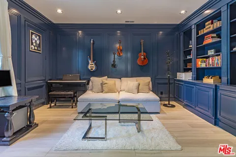 a living room with furniture piano and a flat screen tv