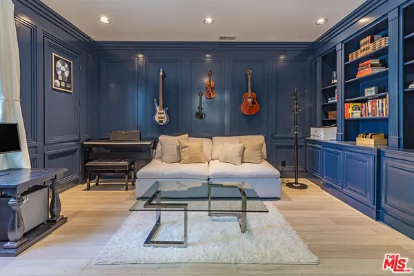 a living room with furniture piano and a flat screen tv