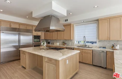a kitchen with a sink a stove a refrigerator and cabinets