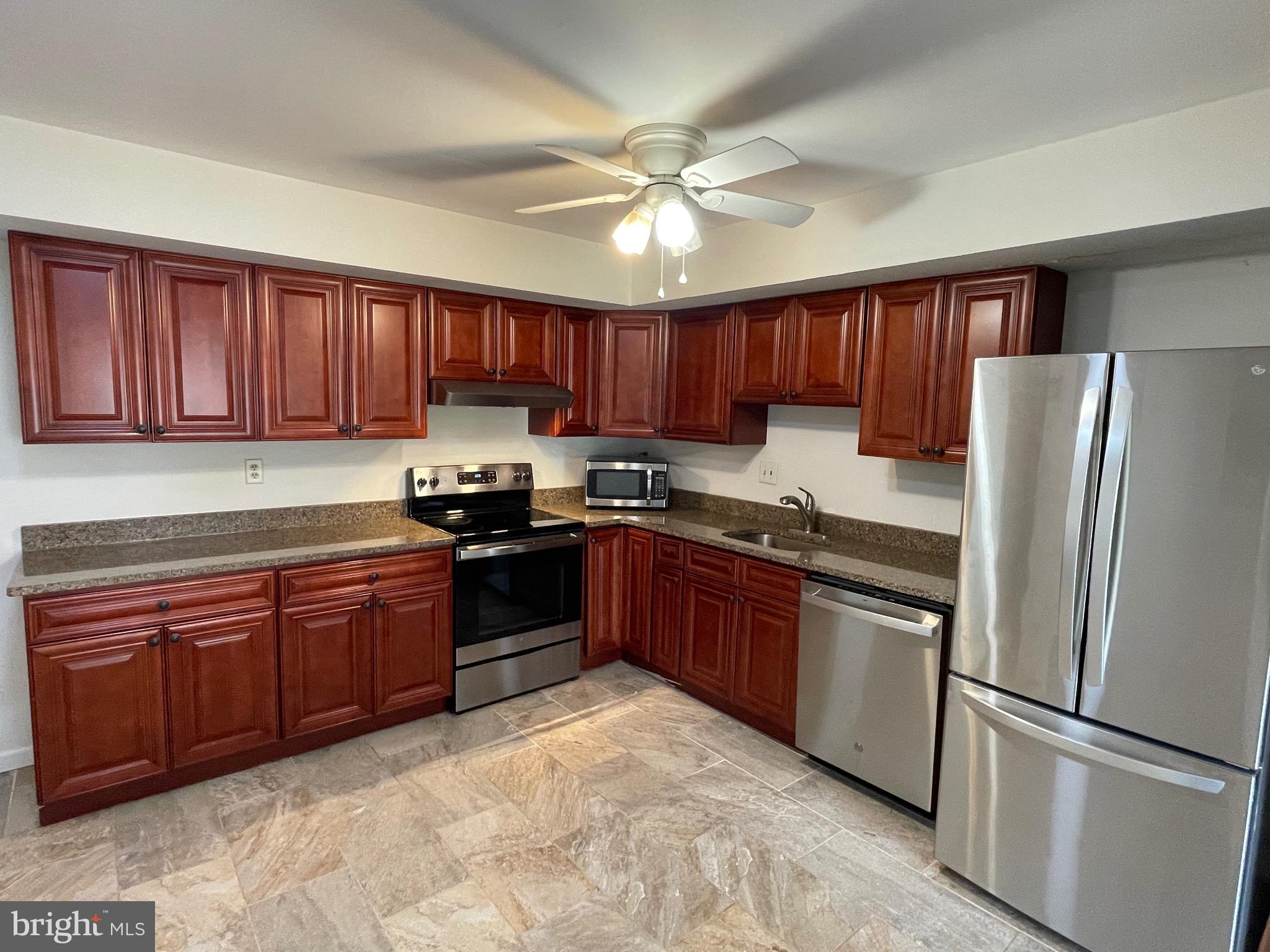 3314 Roxbury Road Hatfield, PA 19440 - Photo 9 of 26 a kitchen with granite countertop stainless steel appliances and wooden cabinets