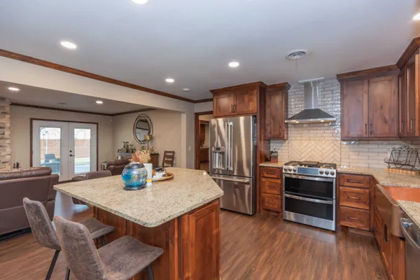a kitchen with a dining table chairs and flat screen tv