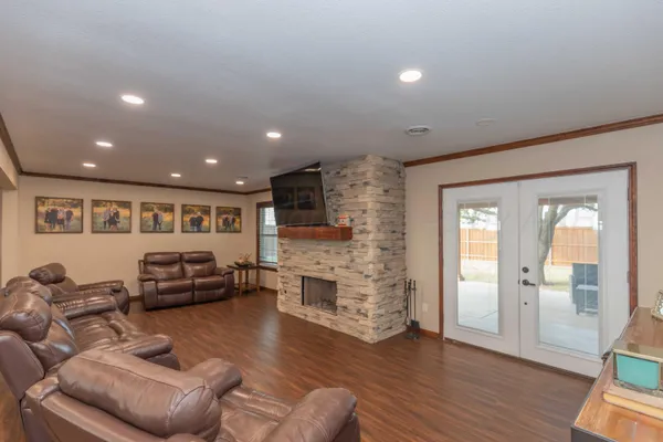 a living room with fireplace furniture and a flat screen tv