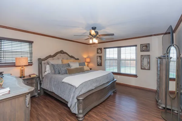 a bedroom with a bed and a chandelier