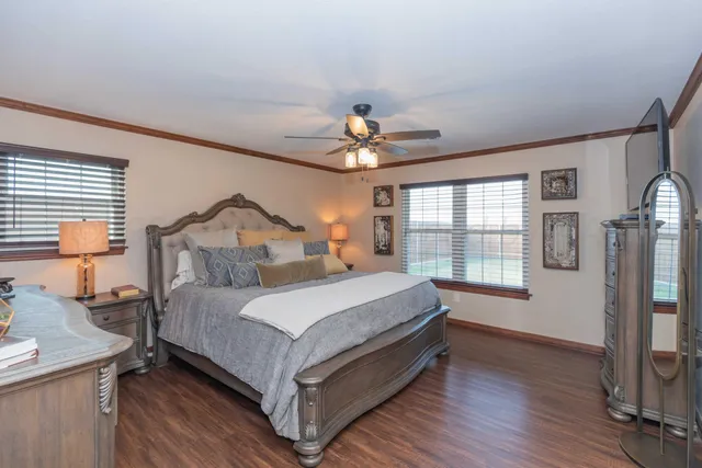 a bedroom with a bed and a chandelier