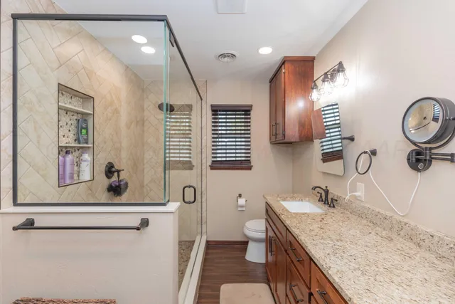 a bathroom with a granite countertop sink and a mirror